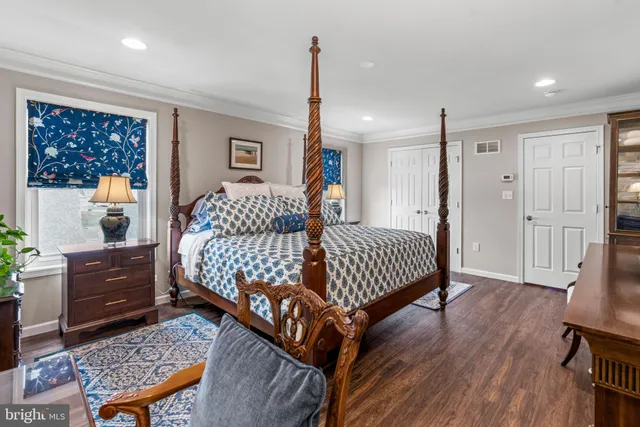 a bedroom with a bed window and a dresser