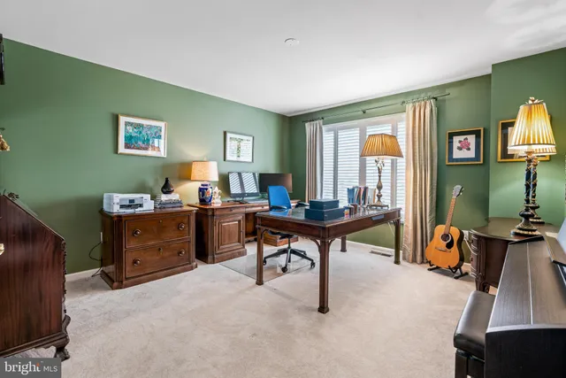 a view of a livingroom with workspace and a window