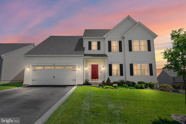 a front view of a house with a garden and plants