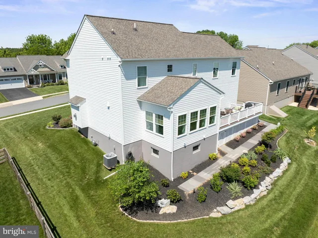a aerial view of a house next to a yard
