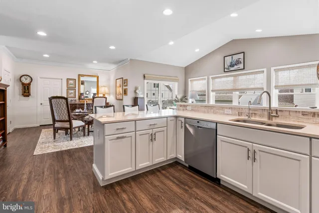 a kitchen with sink cabinets and wooden floor