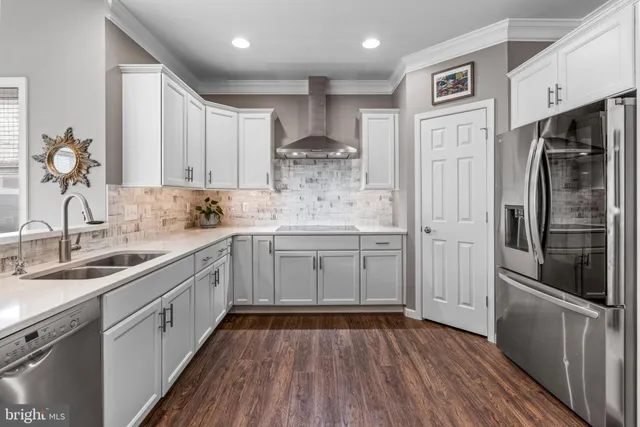 a kitchen with a sink appliances and cabinets
