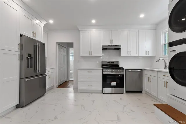 a kitchen with stainless steel appliances granite countertop a refrigerator stove and a sink