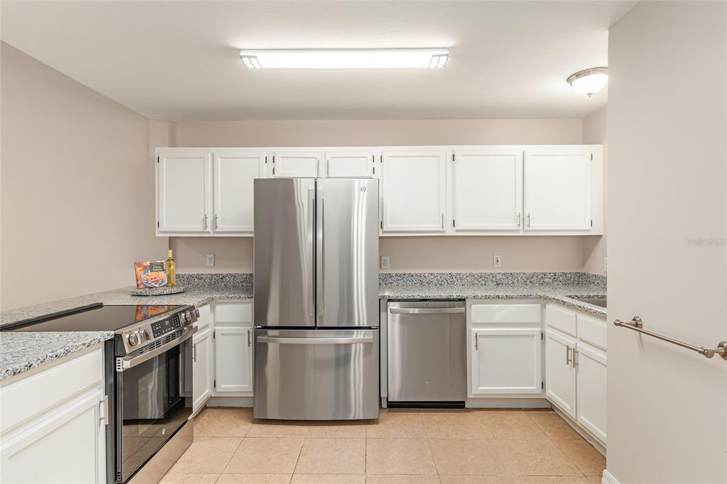 9755 Southwest 52nd Road Gainesville, FL 32608 - Photo 2 of 43 a kitchen with a stove sink and refrigerator