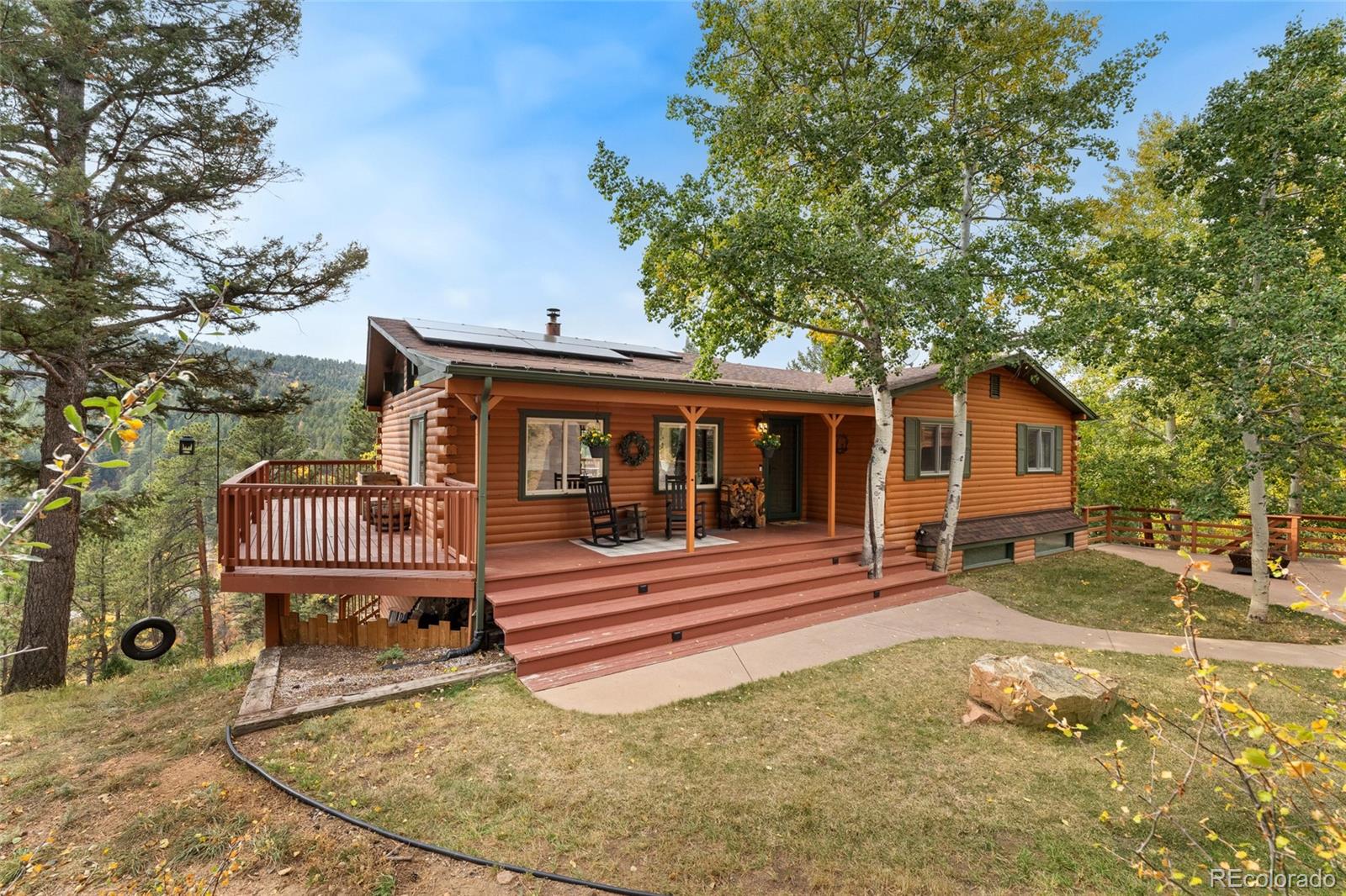 24333 Bent Feather Road Conifer, CO 80433 - Photo 1 of 50 a view of a house with backyard and sitting area