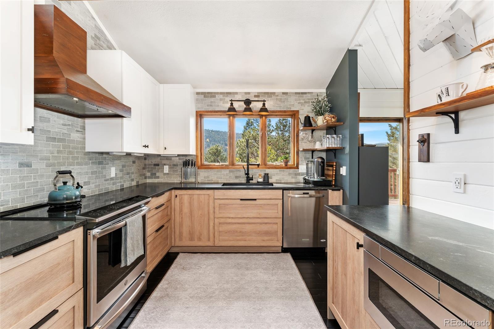 24333 Bent Feather Road Conifer, CO 80433 - Photo 15 of 50 a kitchen with a sink stove and refrigerator