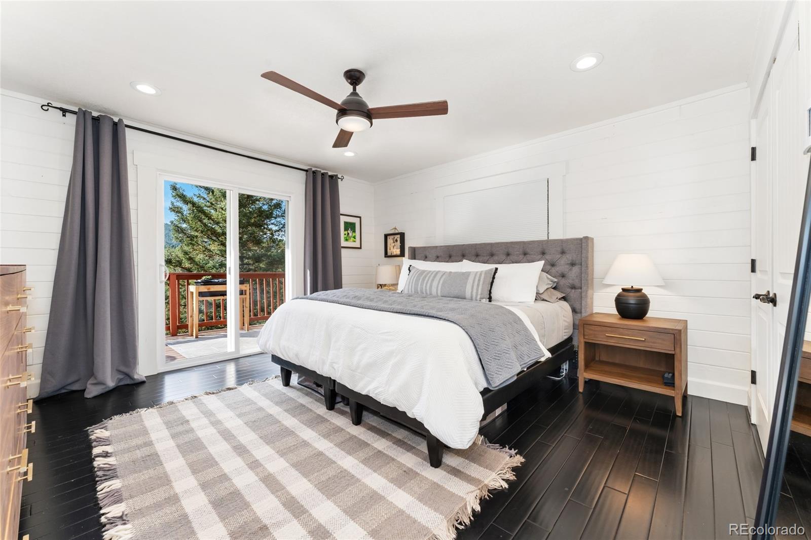24333 Bent Feather Road Conifer, CO 80433 - Photo 18 of 50 a bedroom with a large bed and a large window
