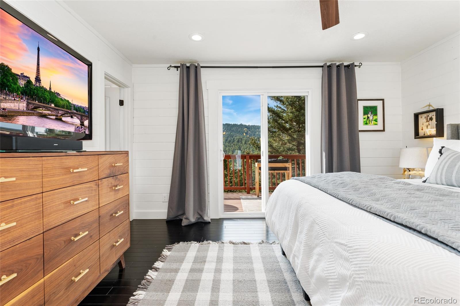 24333 Bent Feather Road Conifer, CO 80433 - Photo 19 of 50 a bedroom with a bed and a window