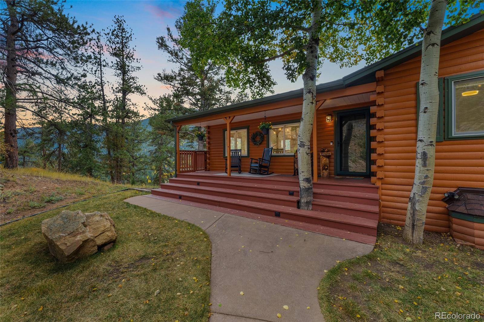 24333 Bent Feather Road Conifer, CO 80433 - Photo 2 of 50 a view of a house with a yard