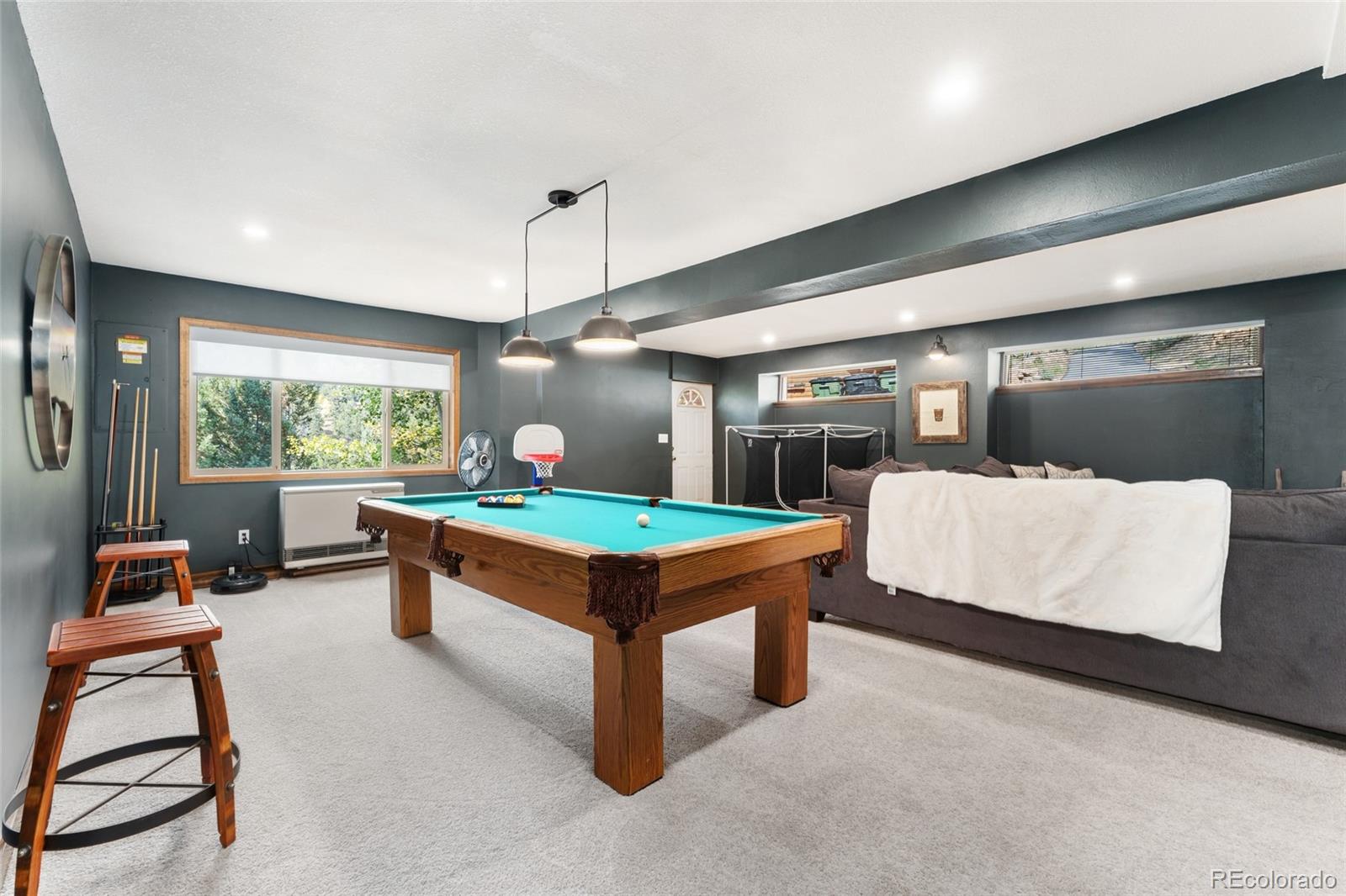 24333 Bent Feather Road Conifer, CO 80433 - Photo 29 of 50 a living room with furniture a pool table and a large window