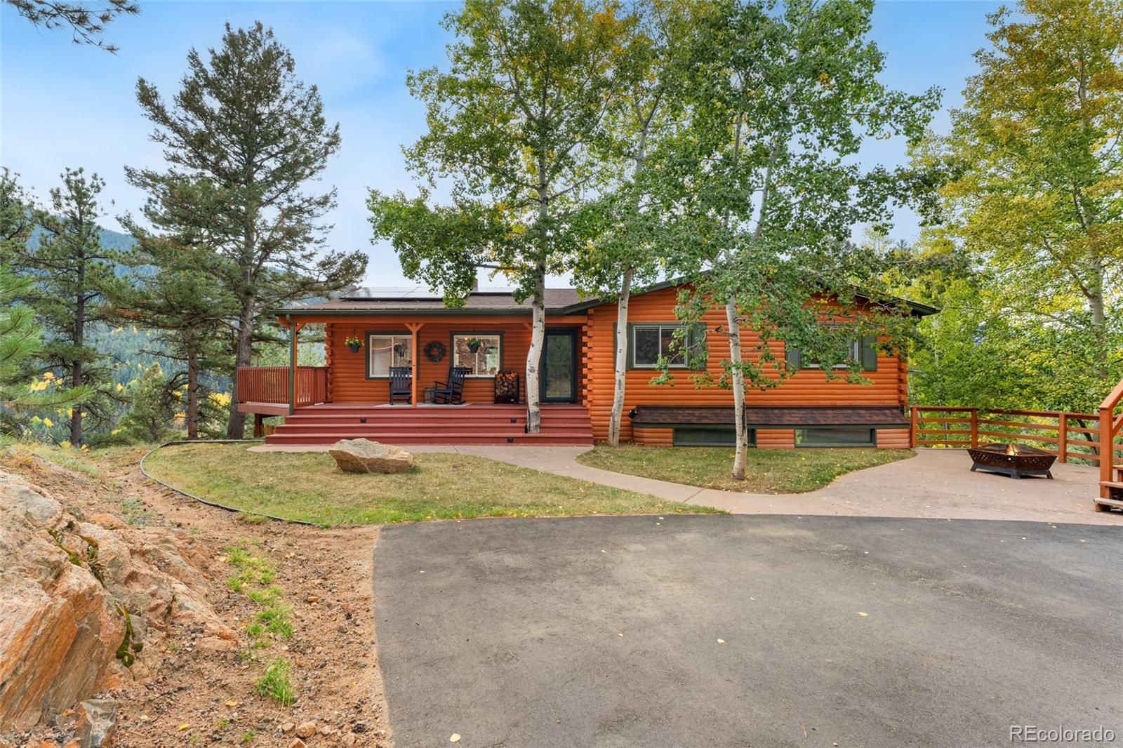 24333 Bent Feather Road Conifer, CO 80433 - Photo 3 of 50 a view of a house with a backyard and trees
