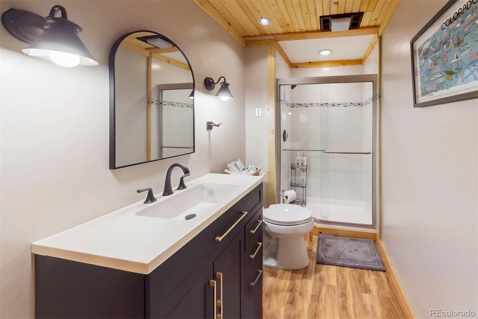 24333 Bent Feather Road Conifer, CO 80433 - Photo 33 of 50 a bathroom with a sink and a mirror