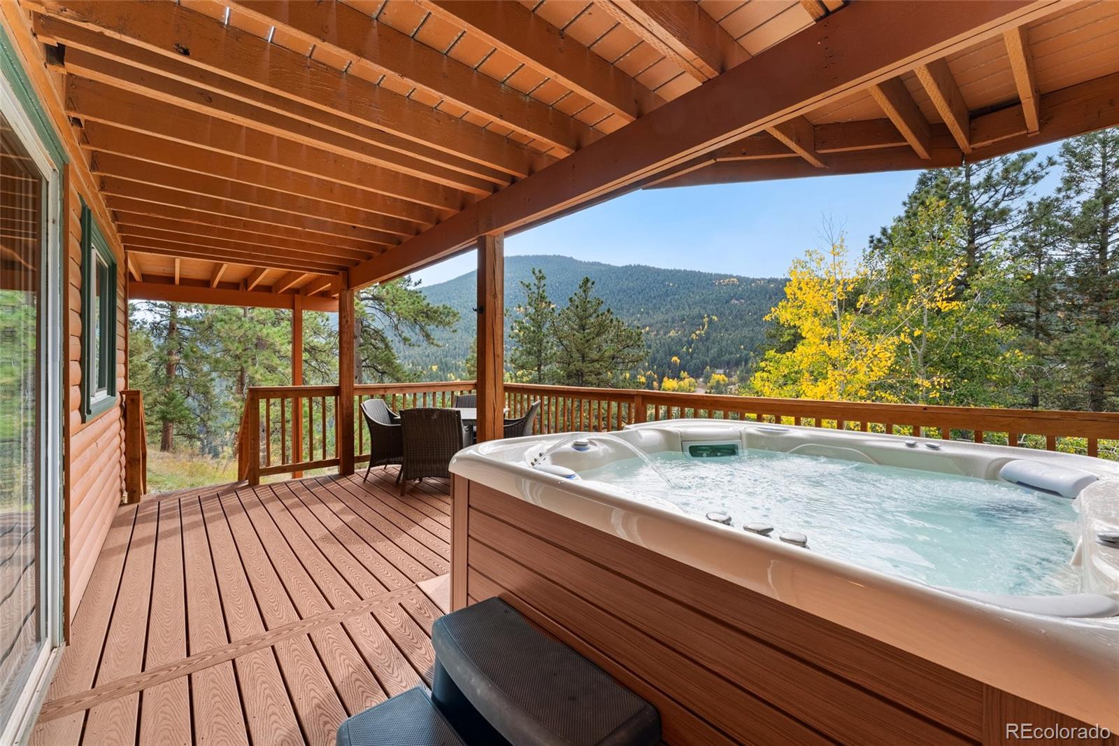 24333 Bent Feather Road Conifer, CO 80433 - Photo 37 of 50 a balcony with wooden floor