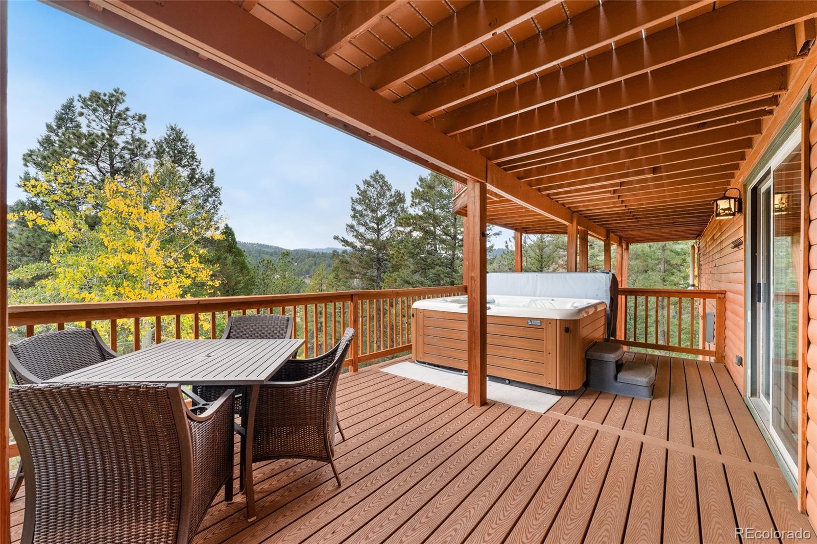 24333 Bent Feather Road Conifer, CO 80433 - Photo 39 of 50 a view of a chairs in wooden deck