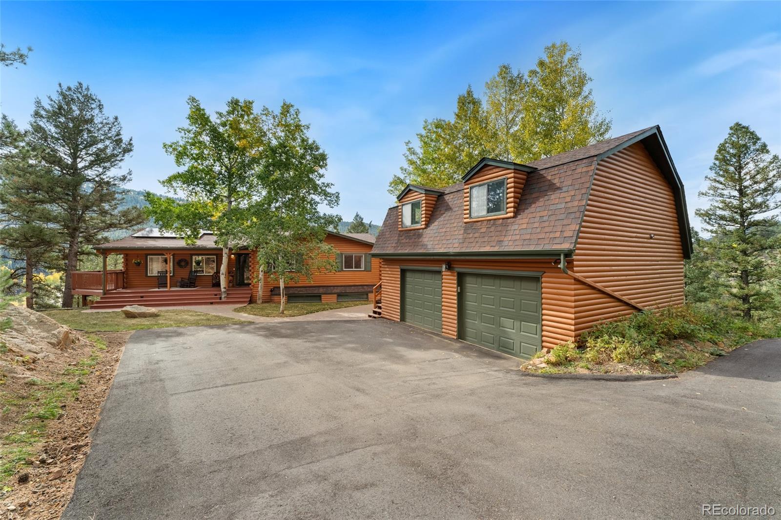 24333 Bent Feather Road Conifer, CO 80433 - Photo 4 of 50 a front view of a house with a garden