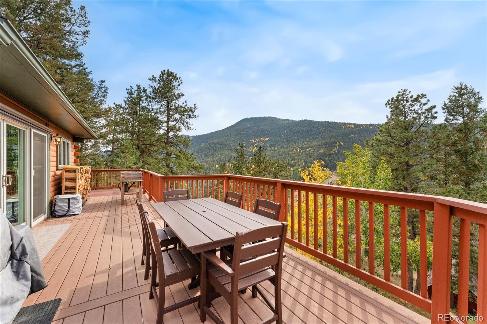 24333 Bent Feather Road Conifer, CO 80433 - Photo 41 of 50 a view of balcony with wooden floor and outdoor seating