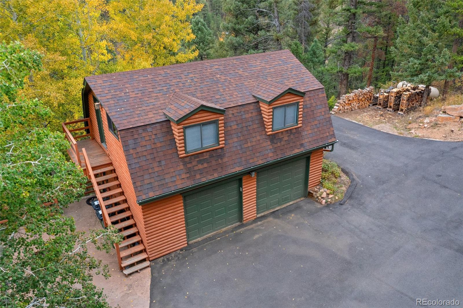 24333 Bent Feather Road Conifer, CO 80433 - Photo 43 of 50 a aerial view of a house with a yard and balcony