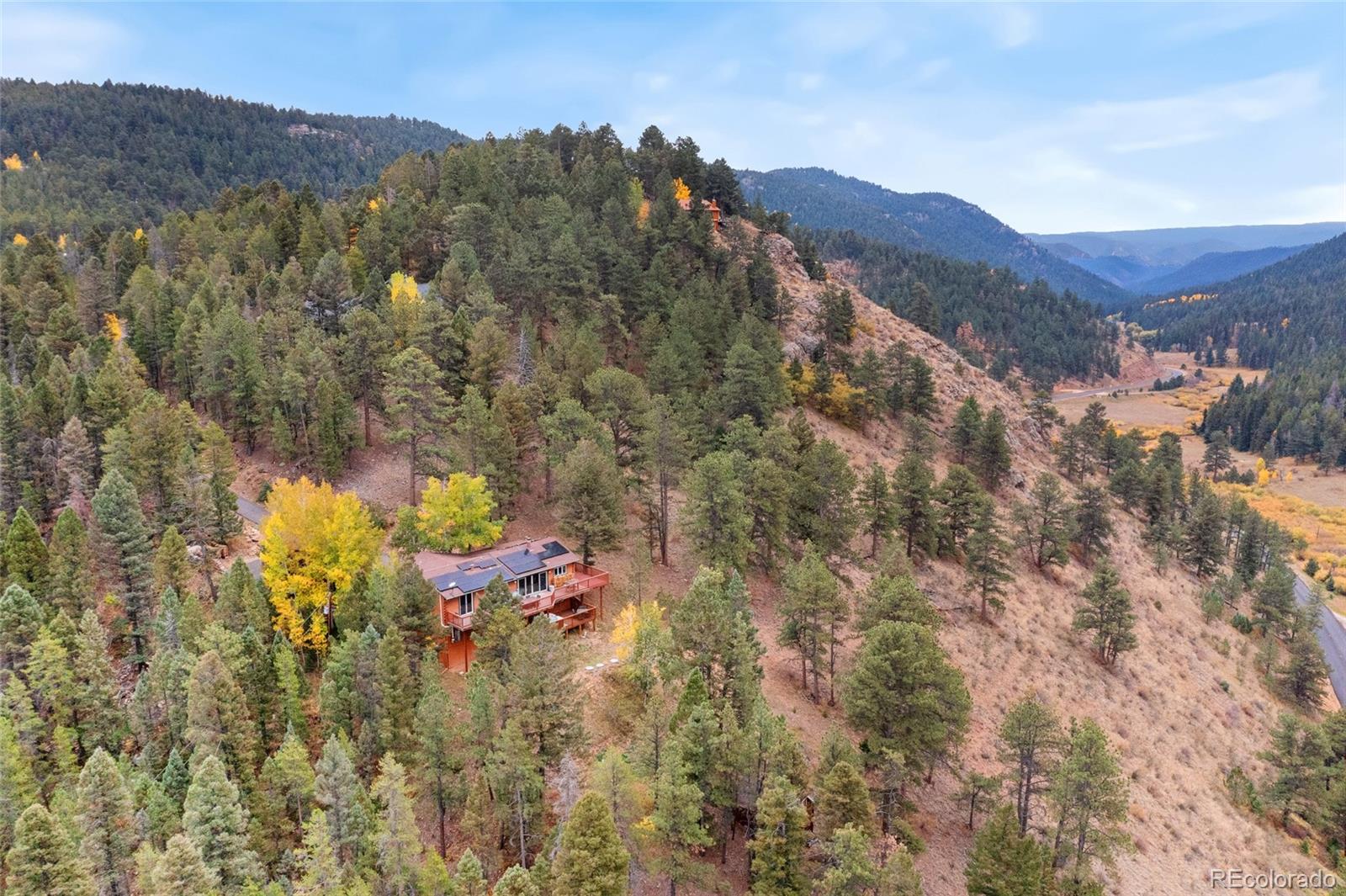 24333 Bent Feather Road Conifer, CO 80433 - Photo 45 of 50 a view of a forest with mountains in the background