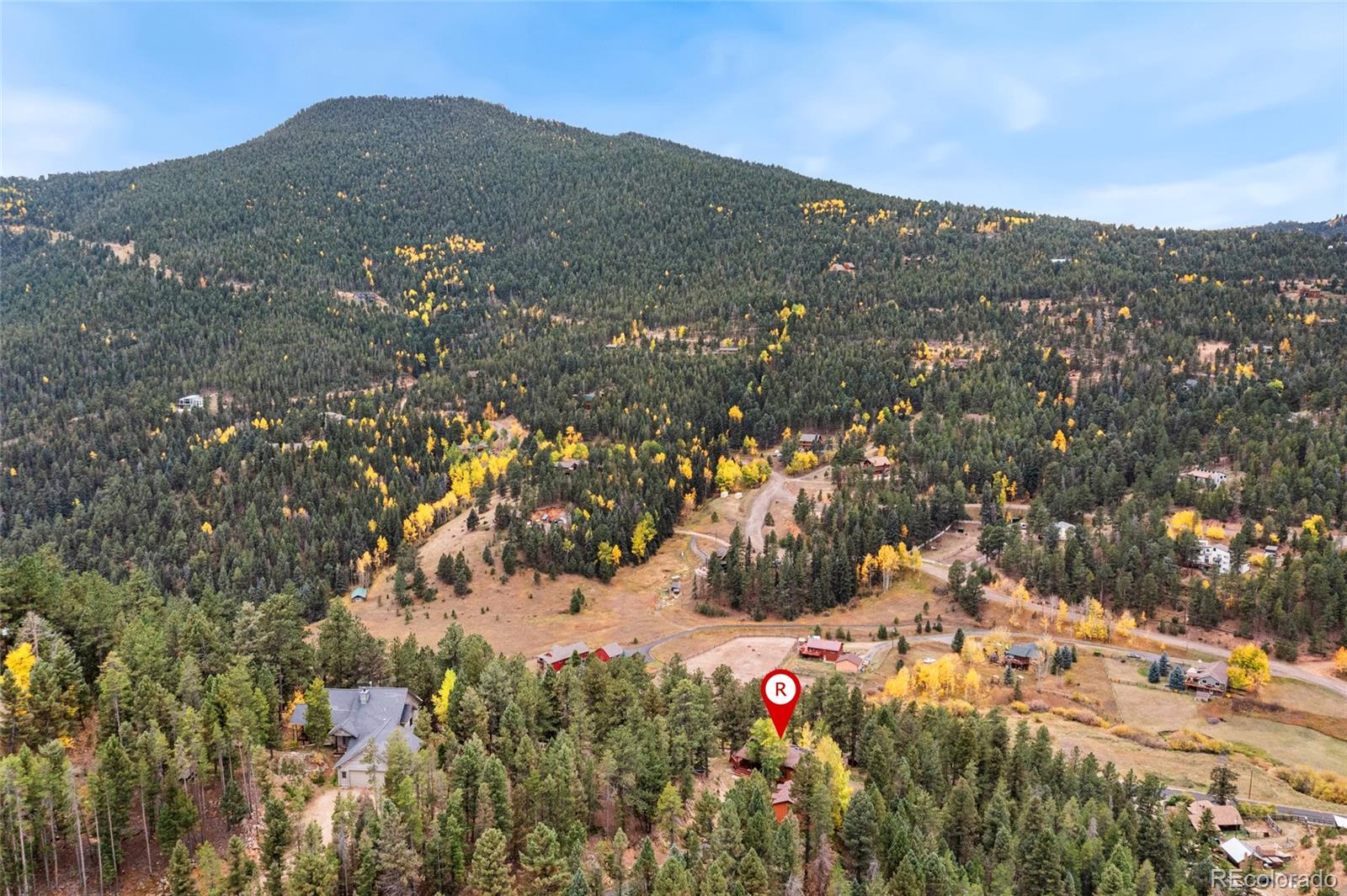 24333 Bent Feather Road Conifer, CO 80433 - Photo 47 of 50 a view of a house with a mountain