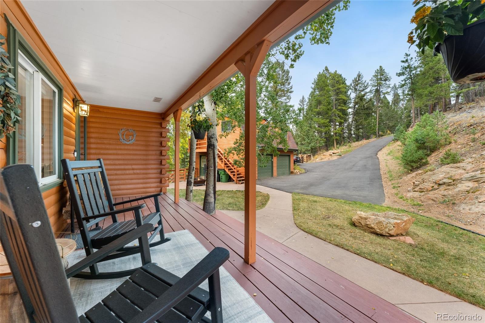 24333 Bent Feather Road Conifer, CO 80433 - Photo 5 of 50 a view of a chairs and table in the balcony