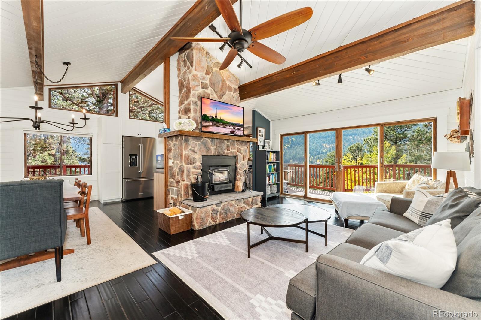 24333 Bent Feather Road Conifer, CO 80433 - Photo 6 of 50 a living room with furniture and a fireplace