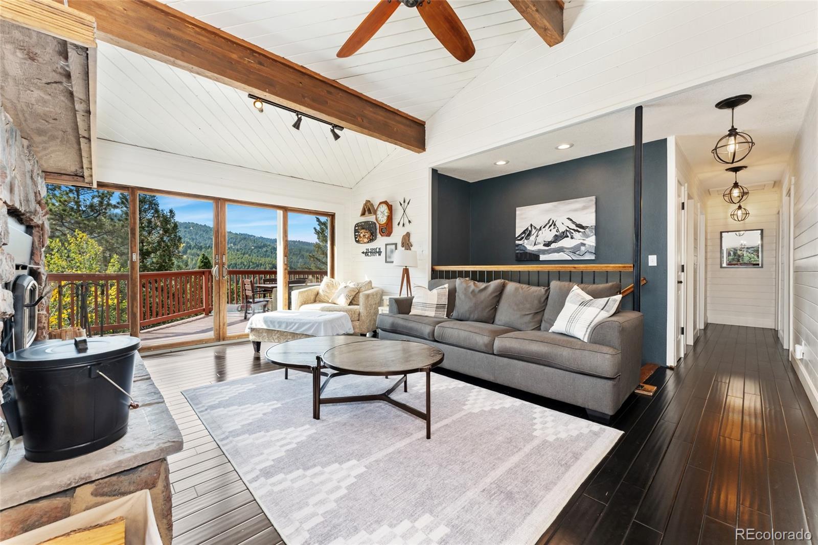 24333 Bent Feather Road Conifer, CO 80433 - Photo 7 of 50 a living room with furniture and a floor to ceiling window