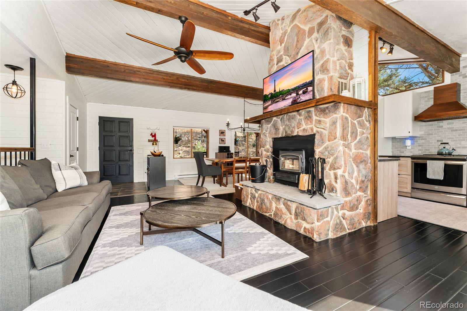 24333 Bent Feather Road Conifer, CO 80433 - Photo 9 of 50 a living room with furniture and a fireplace