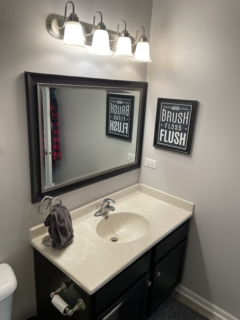 3350 Ravinia Circle Aurora, IL 60504 - Photo 11 of 11 a bathroom with a sink and a mirror
