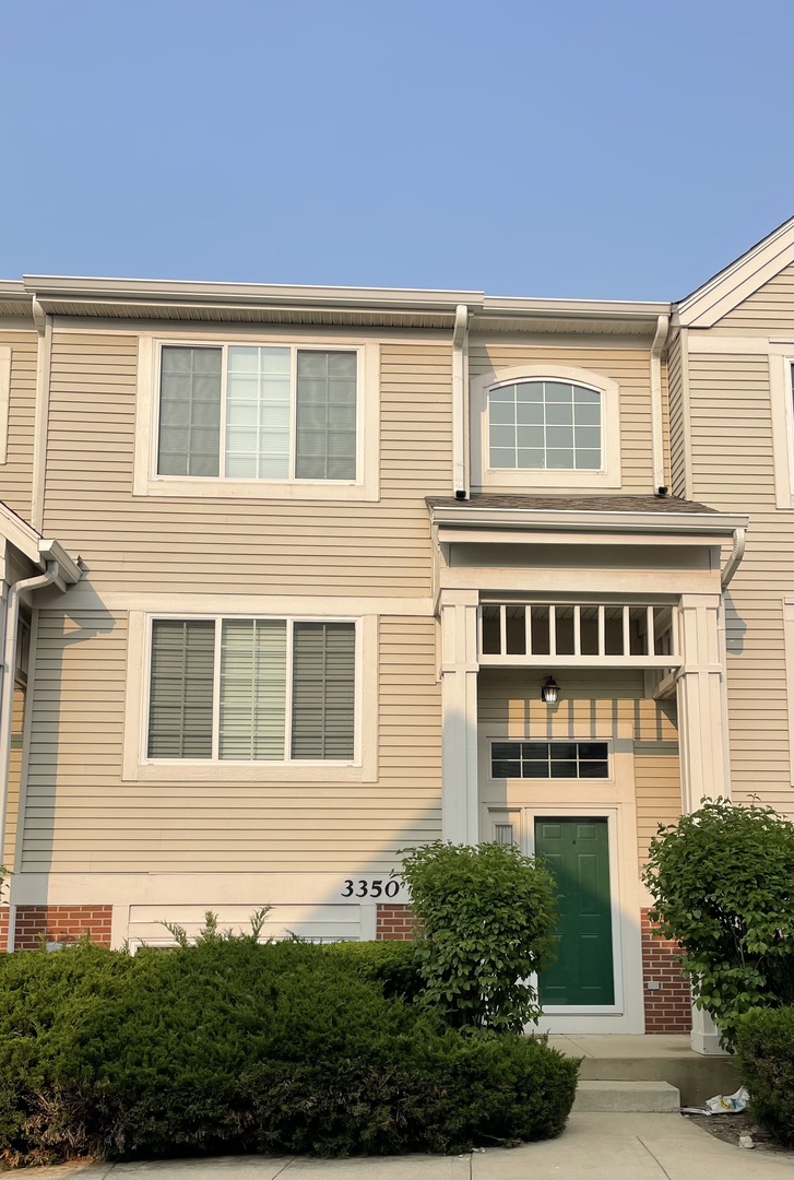 3350 Ravinia Circle Aurora, IL 60504 - Photo 2 of 11 a front view of a house with a yard