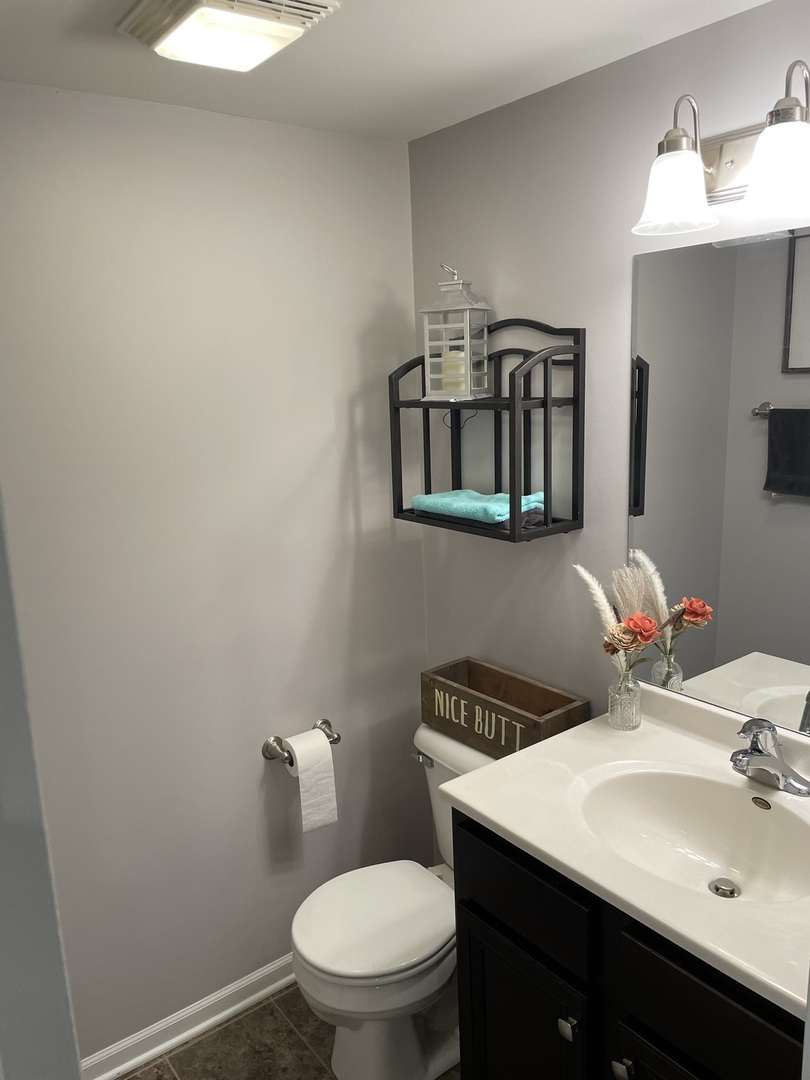 3350 Ravinia Circle Aurora, IL 60504 - Photo 10 of 11 a bathroom with a toilet a sink and mirror