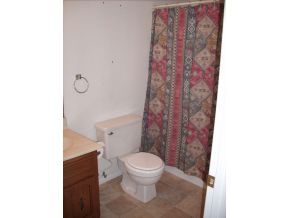 1295 Prairiegrass Road, Unit 2 Chino Valley, AZ 86323 - Photo 3 of 8 a white toilet sitting next to a shower curtain
