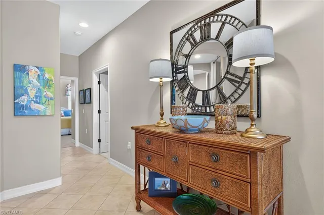 a view of hall way with mirror and furniture
