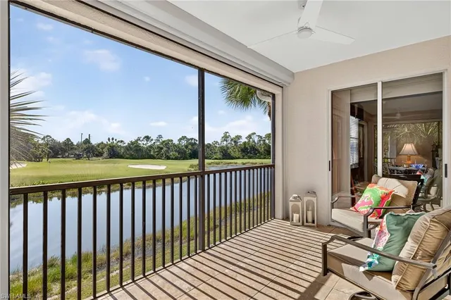 a balcony with wooden floor and outdoor seating