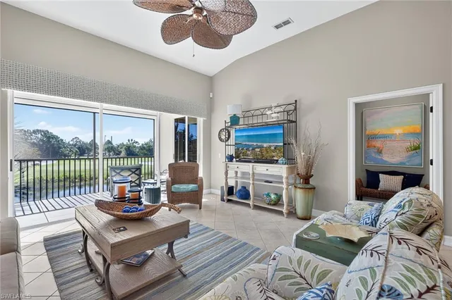 a living room with furniture and a floor to ceiling window