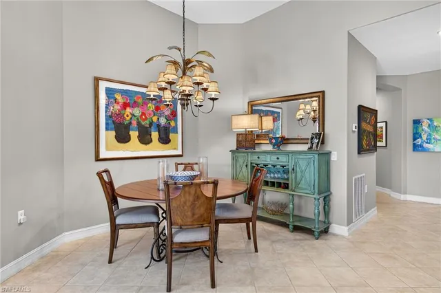 a dining room with furniture and chandelier
