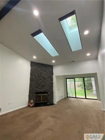 a view of an empty room with sliding glass door and balcony