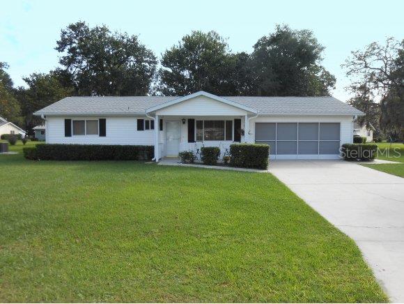 10971 Southwest 76th Terrace Ocala, FL 34476 - Photo 1 of 1 a front view of a house with garden