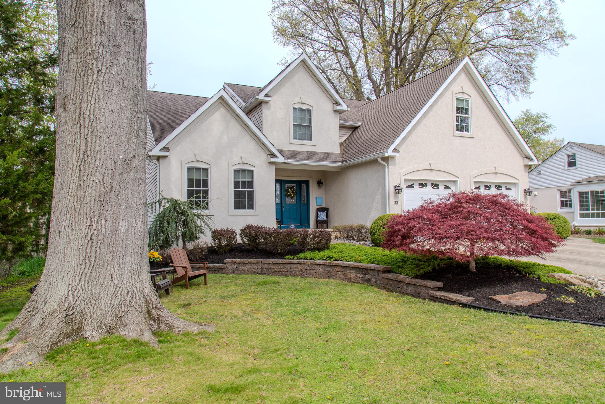 33 Evesham Avenue Marlton, NJ 08053 - Photo 3 of 45 a front view of a house with a garden and trees