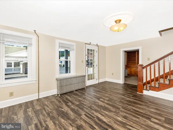 an empty room with closet and a chandelier fan