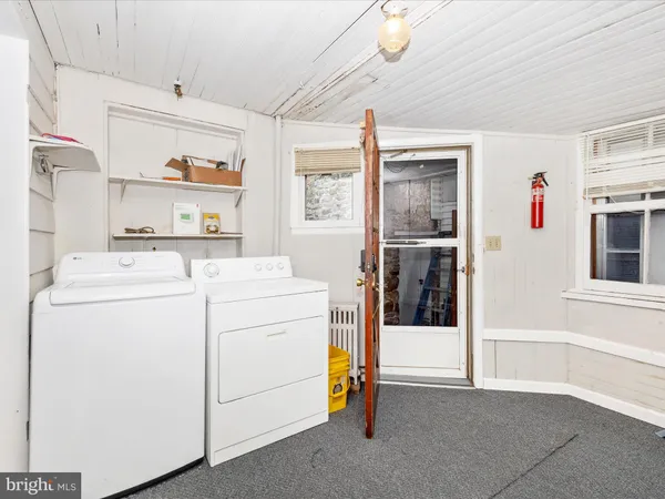 a view of a room with wooden floor and window