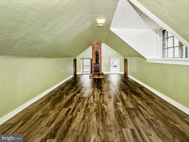a view of wooden floor and windows in a room