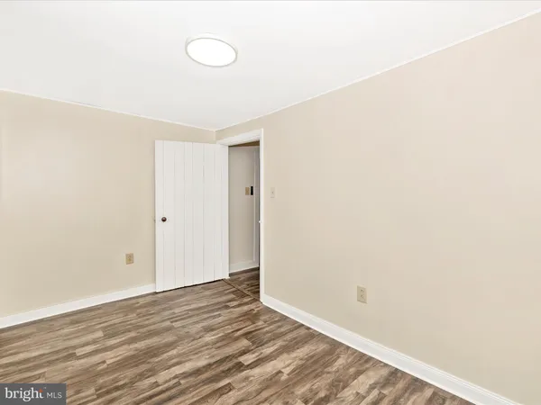 a view of a room with wooden floor and ceiling fan