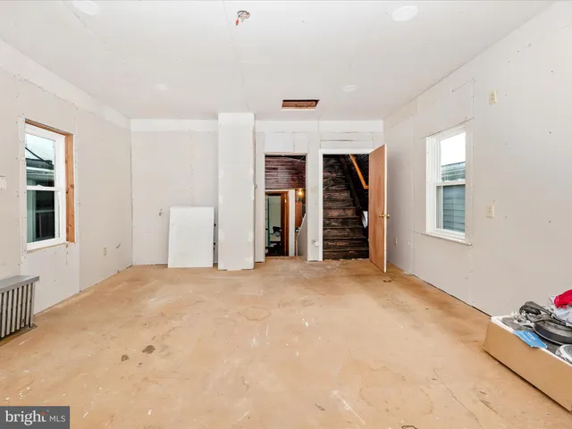 a dining room with furniture and a window