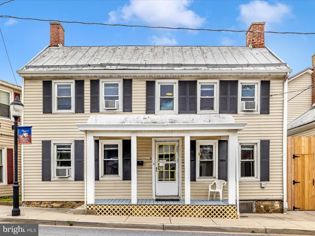 a view of an entryway with wooden floor and door