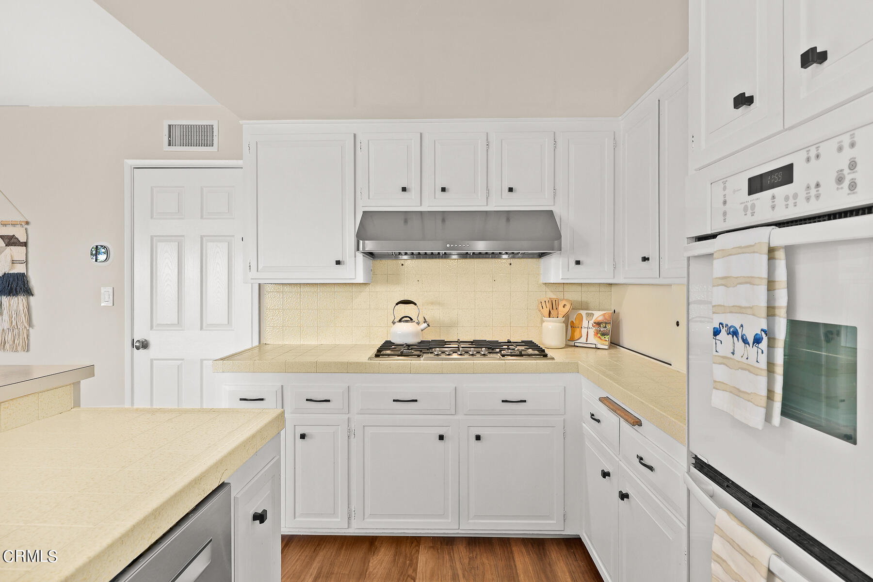 3451 Brookhill Street Glendale, CA 91214 - Photo 29 of 65 a kitchen with granite countertop white cabinets and white appliances