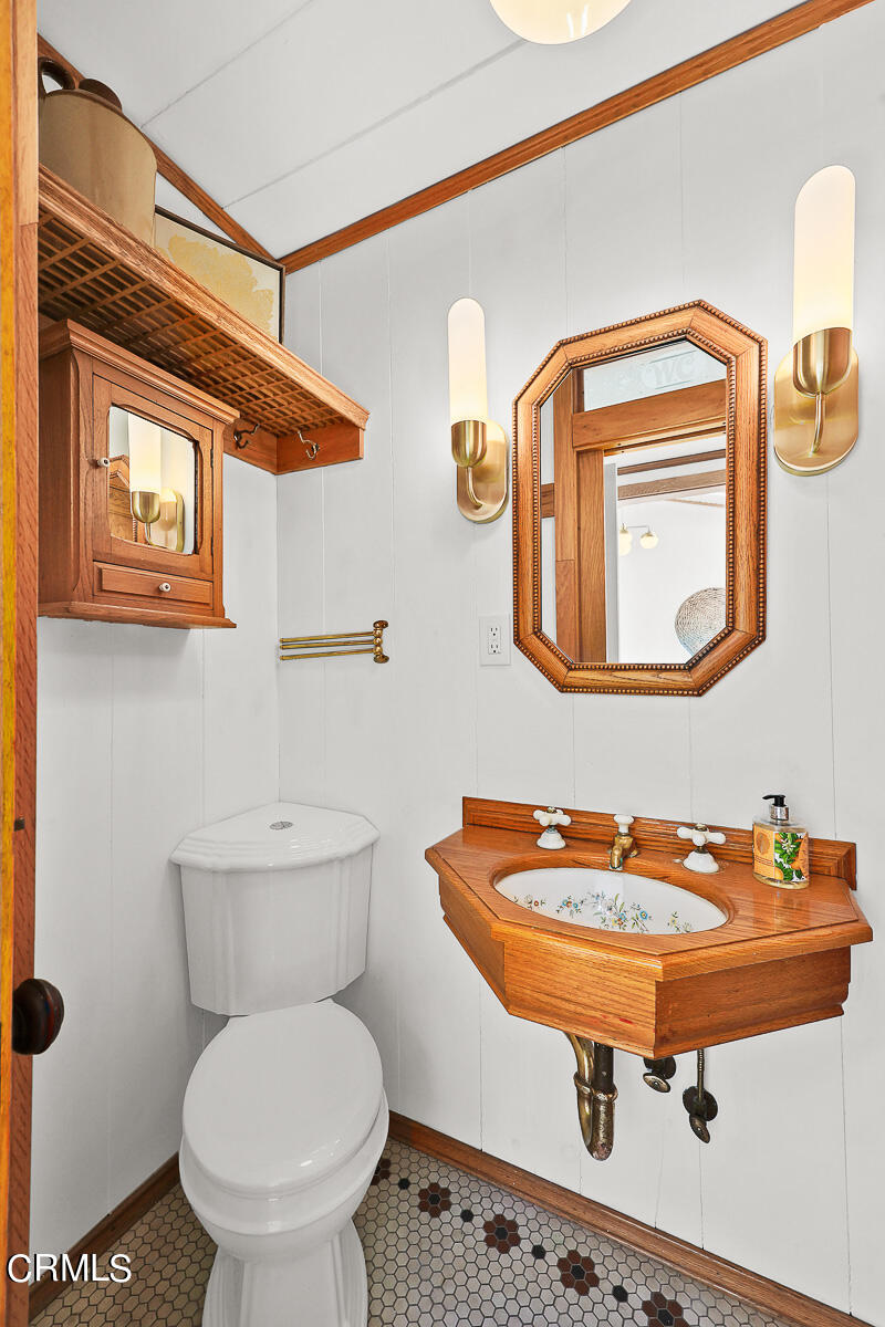 3451 Brookhill Street Glendale, CA 91214 - Photo 33 of 65 a bathroom with a toilet a sink and mirror