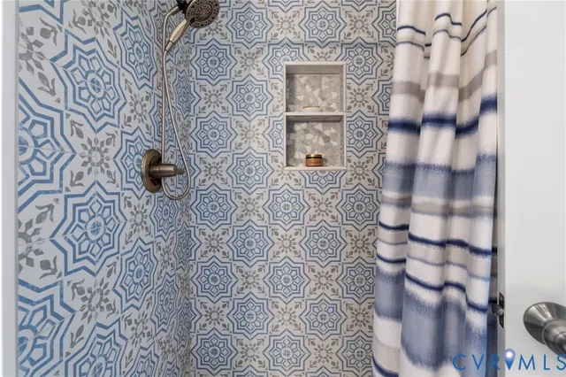a bathroom with a toilet and a shower curtain
