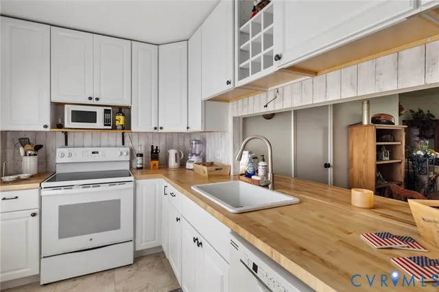 a kitchen with stainless steel appliances granite countertop a sink a stove and cabinets