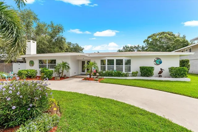 a view of a house with a yard and sitting area