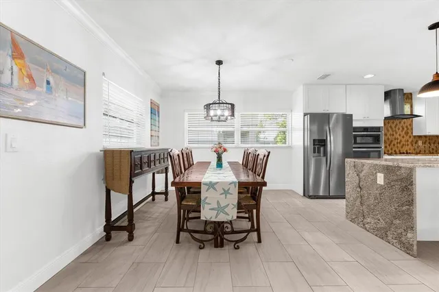 a view of a dining room with furniture and a chandelier